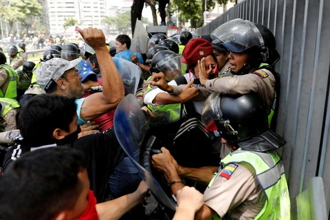 Những người biểu tình đụng độ với lực lượng an ninh trong một cuộc biểu tình ở Caracas. (Nguồn: Reuters)