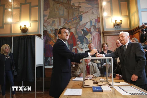 Ứng cử viên Emmanuel Macron (giữa) bỏ phiếu tại một địa điểm bầu cử ở Le Touquet. ​(Nguồn: AFP/TTXVN)