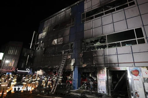 Lính cứu hỏa làm nhiệm vụ tại hiện trường vụ cháy trung tâm thể hình ở thành phố Jecheon. (Nguồn: CNN/TTXVN)