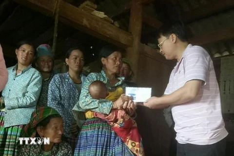 Lãnh đạo huyện Sốp Cộp động viên, hỗ trợ gia đình các nạn nhân. (Ảnh: Nguyễn Chiến/TTXVN)