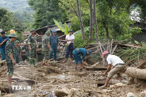 Các lực lượng chức năng giúp đỡ bà con nhân dân khắc phục hậu quả mưa lũ. (Ảnh: Việt Dũng/TTXVN)