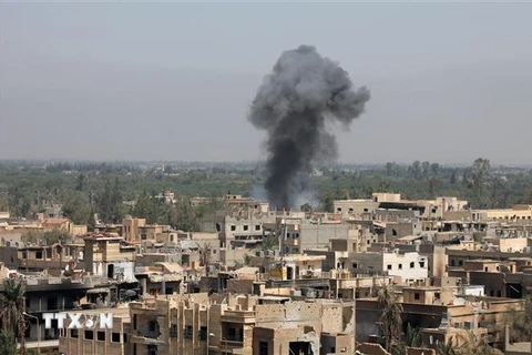 Khói bốc lên sau một cuộc không kích nhằm vào các mục tiêu chiếm đóng của IS tại Deir Ezzor, Syria. (Nguồn: AFP/TTXVN)