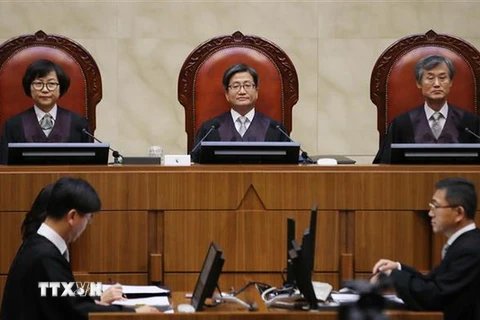 Thẩm phán Kim Meong-su (giữa) ra phán quyết buộc công ty thép Nippon Steel & Sumitomo Metal (NSSM) của Nhật Bản phải trả tiền bồi thường cho lao động cưỡng bức thời chiến tranh tại phiên tòa ở Seoul, Hàn Quốc ngày 30/10/2018. (Nguồn: Yonhap/TTXVN)