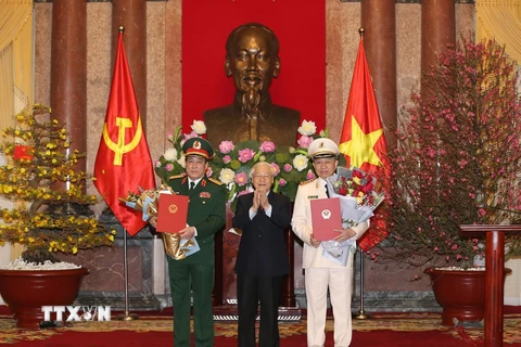 Tổng Bí thư, Chủ tịch nước Nguyễn Phú Trọng trao Quyết định phong quân hàm Đại tướng và tặng hoa chúc mừng các đồng chí Tô Lâm (bên phải), Lương Cường (bên trái). (Ảnh: Trí Dũng/TTXVN)