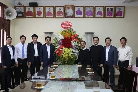 Chủ tịch thành phố Nguyễn Đức Chung chúc mừng Chánh xứ Giáo xứ Thái Hà được tái bổ nhiệm. (Nguồn: thanglong.chinhphu.vn)