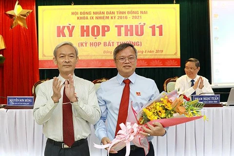 Bí thư Tỉnh ủy, Chủ tịch Hội đồng Nhân dân tỉnh Nguyễn Phú Cường (trái) tặng hoa chúc mừng ông Cao Tiến Dũng. (Nguồn: baodongnai.com.vn)