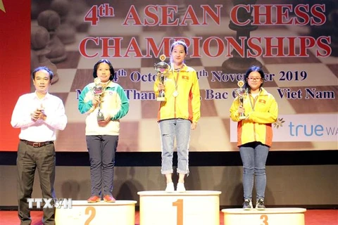 Ban tổ chức trao huy chương và cúp cho các vận động viên đoạt giải nội dung cá nhân nữ - cờ tiêu chuẩn. (Ảnh: Đồng Thúy/TTXVN)