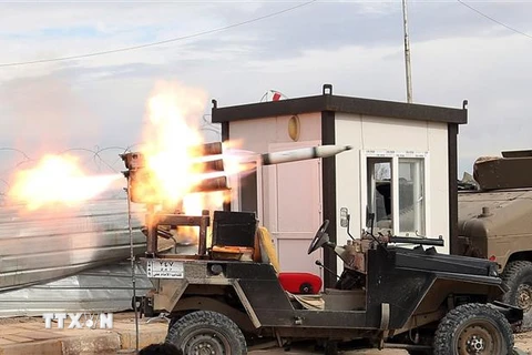 Các thành viên lực lượng vũ trang Iraq phóng rocket nhằm vào các mục tiêu của tổ chức Nhà nước Hồi giáo tự xưng ở tỉnh Tikrit, cách thủ đô Baghdad, Iraq 130km về phía Bắc. (Ảnh: AP/TTXVN)