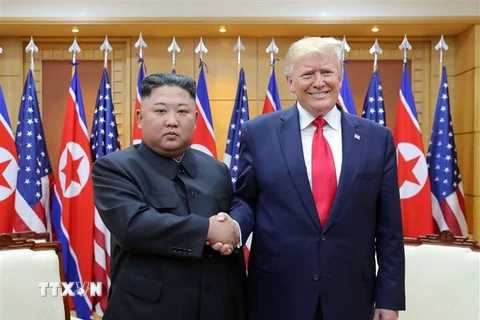 Nhà lãnh đạo Triều Tiên Kim Jong-un (trái) và Tổng thống Mỹ Donald Trump (phải) trong cuộc gặp tại Khu phi quân sự ở biên giới liên Triều ngày 30/6/2019. (Ảnh: AFP/TTXVN)