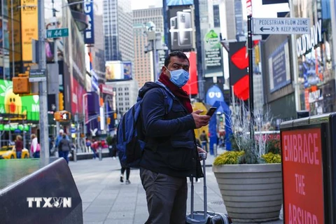 Người dân đeo khẩu trang để phòng tránh lây nhiễm COVID-19 tại New York, Mỹ. (Ảnh: AFP/TTXVN)