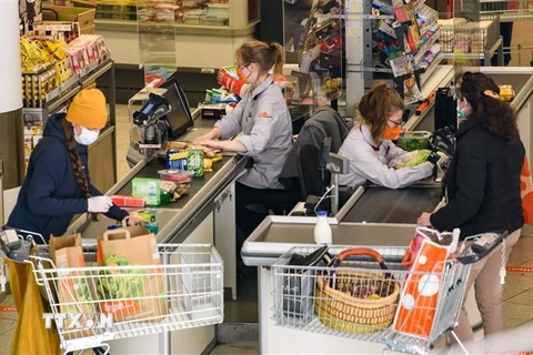 Người dân mua hàng tại siêu thị ở Jena, Đức, trong bối cảnh dịch COVID-19 bùng phát. (Ảnh: THX/TTXVN)