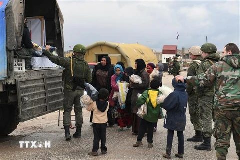 Phát hàng cứu trợ cho người dân Syria ở Abu Duhur, tỉnh Idlib. (Ảnh: AFP/TTXVN)