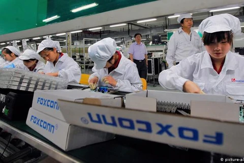 Một dây chuyển lắp ráp của Công ty Foxconn chuyên lắp ráp điệ thoại iPhone của Apple. (Nguồn: DPA)