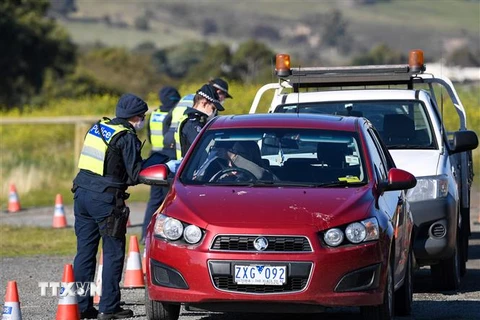 Cảnh sát Australia kiểm tra các phương tiện ở ngoại ô thành phố Melbourne, bang Victoria trong nỗ lực ngăn chặn sự lây lan của dịch COVID-19. (Ảnh: AFP/TTXVN)