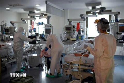 Nhân viên y tế điều trị cho bệnh nhân COVID-19 tại bệnh viện ở Madrid, Tây Ban Nha. (Ảnh: AFP/TTXVN)