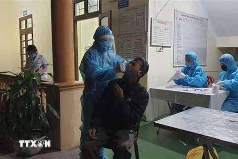Lấy mẫu xét nghiệm SARS-CoV2 tại thành phố Uông Bí, Quảng Ninh. (Ảnh: TTXVN phát)