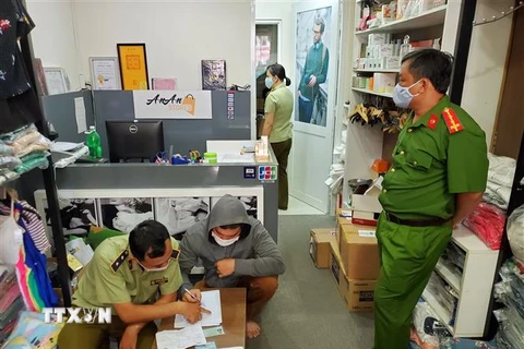 Lực lượng chức năng kiểm tra cửa hàng ở địa chỉ 65A Huỳnh Văn Bánh, quận Phú Nhuận. (Ảnh: Thành Chung/TTXVN)