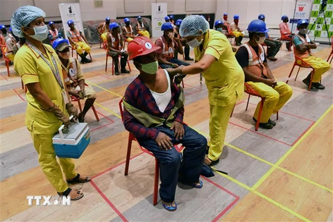 Tiêm chủng vaccine ngừa COVID-19 cho công nhân xây dựng ở Mumbai, Ấn Độ. (Ảnh: AFP/TTXVN)