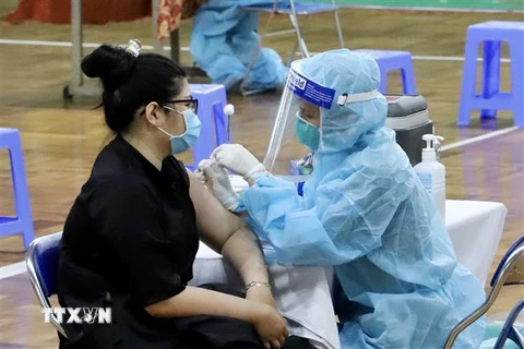 Nhân viên y tế tiêm vaccine cho người dân tại Nhà thi đấu Lãnh Binh Thăng (Quận 11, Thành phố Hồ Chí Minh). (Ảnh: Hồng Giang/TTXVN)