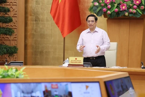 Thủ tướng Phạm Minh Chính chủ trì cuộc họp trực tuyến với lãnh đạo tỉnh Kiên Giang và Tiền Giang. (Ảnh: Dương Giang/TTXVN)