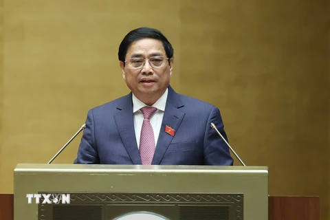 Thủ tướng Phạm Minh Chính trình bày Báo cáo kết quả thực hiện kế hoạch phát triển kinh tế-xã hội năm 2022; dự kiến kế hoạch phát triển kinh tế-xã hội năm 2023. (Ảnh: Dương Giang/TTXVN)