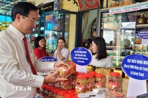 Ông Nguyễn Tấn Bản, Chủ tịch UBND huyện Châu Đức, tham quan gian hàng trưng bày sản phẩm OCOP của huyện. (Ảnh: Hoàng Nhị/TTXVN)