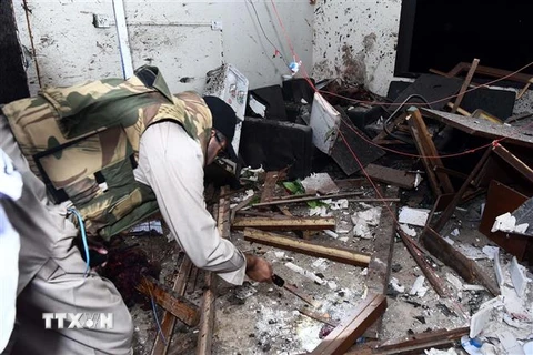 Lực lượng an ninh Pakistan điều tra tại hiện trường vụ tấn công của phiến quân vào trụ sở cơ quan cảnh sát ở Karachi. (Ảnh: THX/TTXVN)
