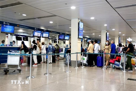 Hành khách làm thủ tục đi máy bay tại Cảng hàng không Tân Sơn Nhất. (Ảnh: Hồng Đạt/TTXVN)