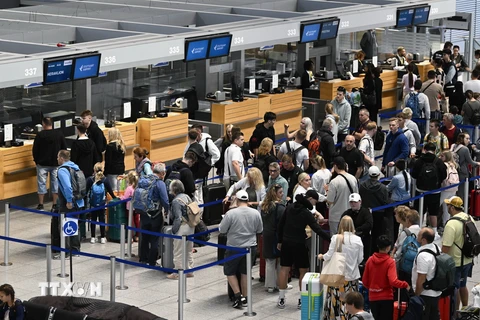 Hành khách tại sân bay Stuttgart ở Leinfelden-Echterdingen, Đức. (Ảnh: AFP/TTXVN)