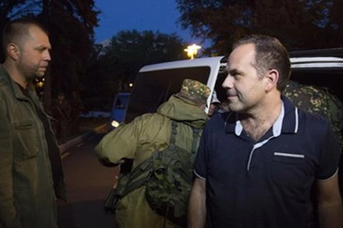 Quan sát viên của OSCE (phải) rời khỏi xe sau khi được đưa tới Donetsk. (Nguồn: Reuters)
