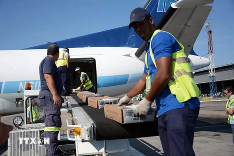 Nhân viên chuyển thư tín lên máy bay tại sân bay quốc tế Jose Marti ở La Habana ngày 16/3. (Ảnh: THX/TTXVN)
