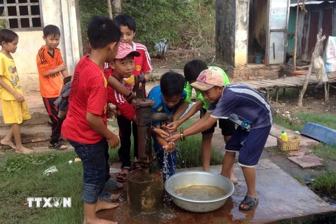 Niềm vui của trẻ em khi có nước sạch sinh hoạt. (Ảnh: Lê Sen/TTXVN)