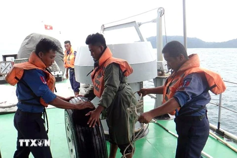 Lực lượng cứu hộ vớt được một chiếc bánh xe của máy bay quân sự bị mất tích ở ngoài khơi tỉnh Launglon ngày 8/6. (Ảnh: THX/TTXVN)