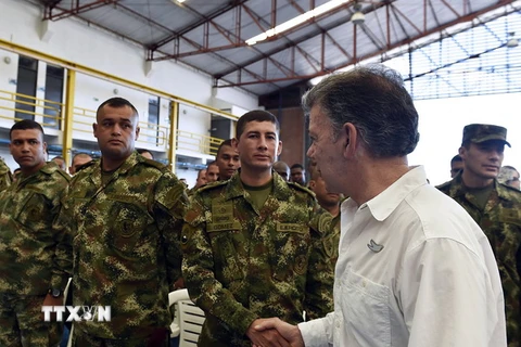 Tổng thống Colombia Juan Manuel Santos (phải) và các binh sỹ thuộc không lực Colombia. (Ảnh: THX/TTXVN)