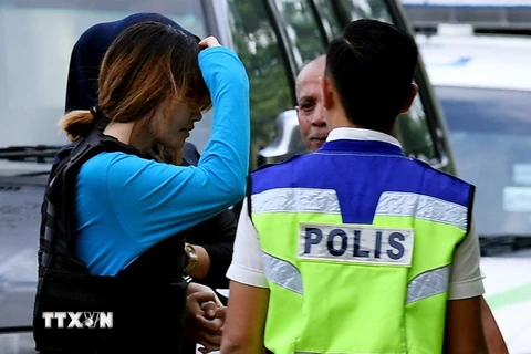 Nghi phạm Đoàn Thị Hương (giữa, trái) được áp giải tới tòa án ở Malaysia. (Ảnh: AFP/TTXVN)