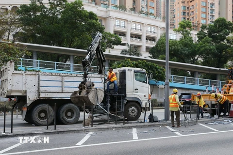 Công nhân dọn dẹp trên tuyến đường ở Mong Kok của Hong Kong, Trung Quốc, sau khi người biểu tình quá khích đập phá tại nhiều tuyến phố. (Ảnh: THX/TTXVN)