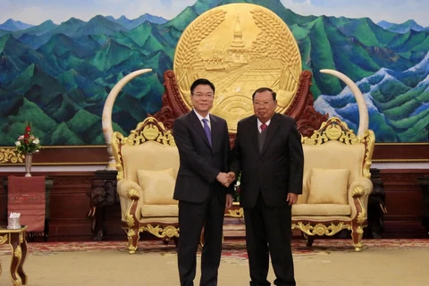 Tổng Bí thư, Chủ tịch nước Lào Bounnhang Vorachith tiếp thân mật Bộ trưởng Bộ Tư pháp Lê Thành Long. (Ảnh: Phạm Kiên/TTXVN)