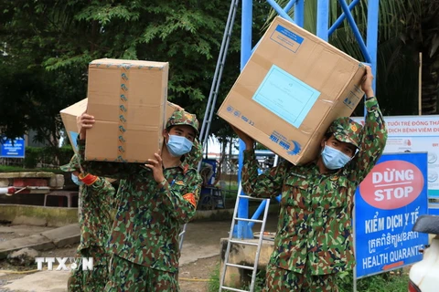 Bộ đội Biên phòng Đồng Tháp hỗ trợ vận chuyển 50.000 khẩu trang và 500 bộ đồ bảo hộ y tế trị giá hơn 90 triệu đồng trao tặng thanh niên tỉnh Prey Veng của Campuchia để phòng, chống dịch COVID-19. (Ảnh: Chương Đài/TTXVN)