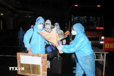 Tặng hoa chúc mừng các thành viên Đoàn cán bộ y tế Sơn La tham gia hỗ trợ chống dịch COVID-19 tại Thành phố Hồ Chí Minh trở về. (Ảnh: Quang Quyết/TTXVN)