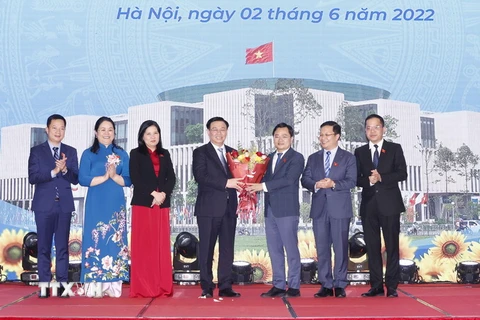 Nhóm Đại biểu Quốc hội trẻ khóa XV tặng hoa Chủ tịch Quốc hội Vương Đình Huệ. (Ảnh: Doãn Tấn/TTXVN)