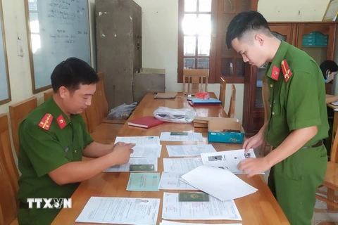 Cán bộ Công an huyện Hưng Hà, tỉnh Thái Bình thu thập hồ sơ, tài liệu để làm rõ hành vi phạm tội của đối tượng. (Ảnh: TTXVN phát)