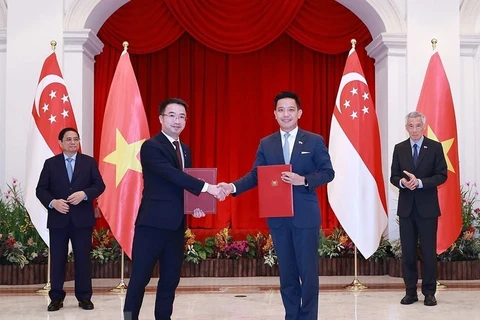 Thủ tướng Phạm Minh Chính và Thủ tướng Singapore Lý Hiển Long chứng kiến lễ trao văn kiện hợp tác giữa hai nước tại Singapore ngày 9/2/2023. (Ảnh: Dương Giang/TTXVN)