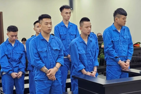 Trần Văn Huy (hàng đầu, thứ hai từ trái qua) có vai trò chính trong vụ án mua bán người. (Nguồn: Báo Lao động)