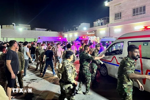 Binh sỹ và lực lượng phản ứng nhanh Iraq chuyển các nạn nhân vụ hỏa hoạn trong đám cưới tới bệnh viện Hamdaniyah ở Al-Hamdaniyah, Iraq ngày 27/9. (Ảnh: AFP/TTXVN)