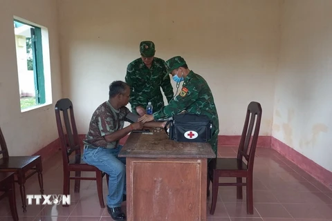 Bộ đội biên phòng tỉnh Đắk Lắk thăm khám ban đầu cho bệnh nhân. (Ảnh: TTXVN phát)