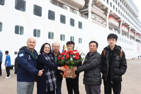 Lãnh đạo Sở Du Lịch tặng hoa chúc mừng du khách đến Quảng Ninh. (Nguồn: báo Quảng Ninh)