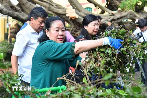 Bí thư Thành ủy Hà Nội Bùi Thị Minh Hoài tham gia vệ sinh môi trường cùng người dân tại phố Trần Hưng Đạo, quận Hoàn Kiếm. (Ảnh: TTXVN phát)