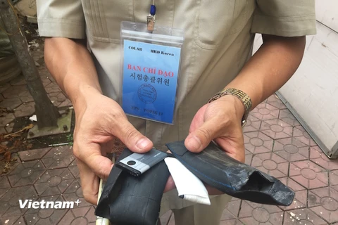Điện thoại bọc cao su được ném từ ngoài vào phòng thi cho thí sinh và bị rơi vỡ. (Nguồn: Hồng Kiều/Vietnam+)