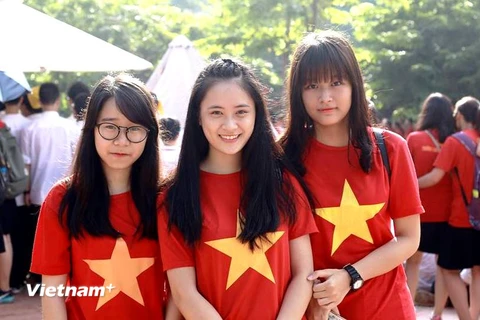 Các nữ sinh trường Lương Thế Vinh trong trang phục cờ đỏ sao vàng. (Ảnh: Tùng Lâm/Vietnam+)