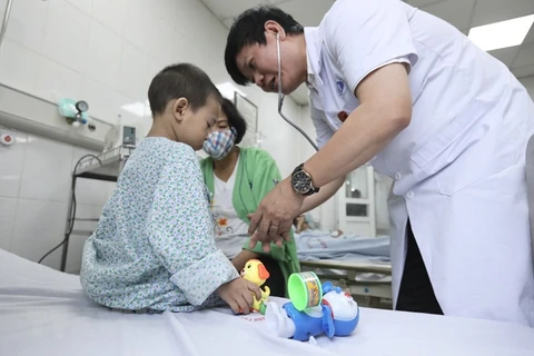 Bác sỹ thăm khám cho các bệnh nhân trong vụ cháy chung cư mini tại quận Thanh Xuân, Hà Nội. (Ảnh: Minh Quyết/TTXVN)